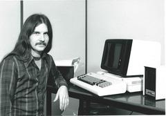 Photo: Man posing with the IBM 3101 ASCII terminal and microWAT